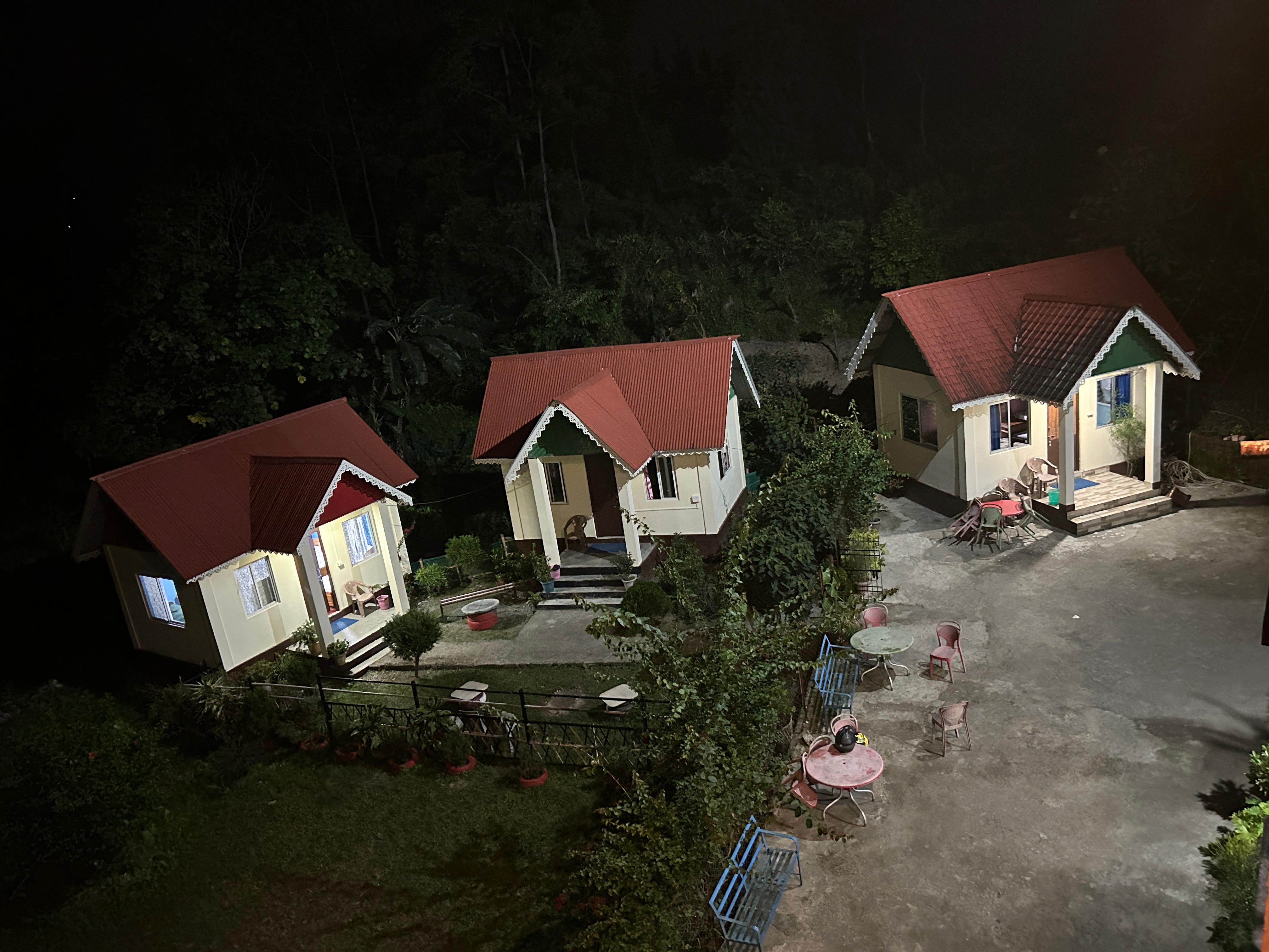 Titus Chhalamkyong Homestay cottages at night